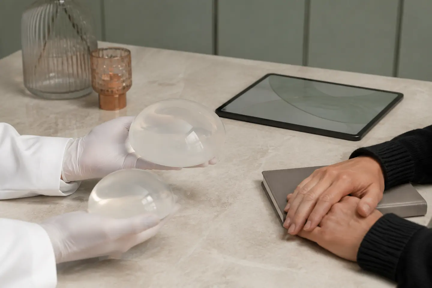 Tabletop scene illustrating comparison of breast implant options during consultation